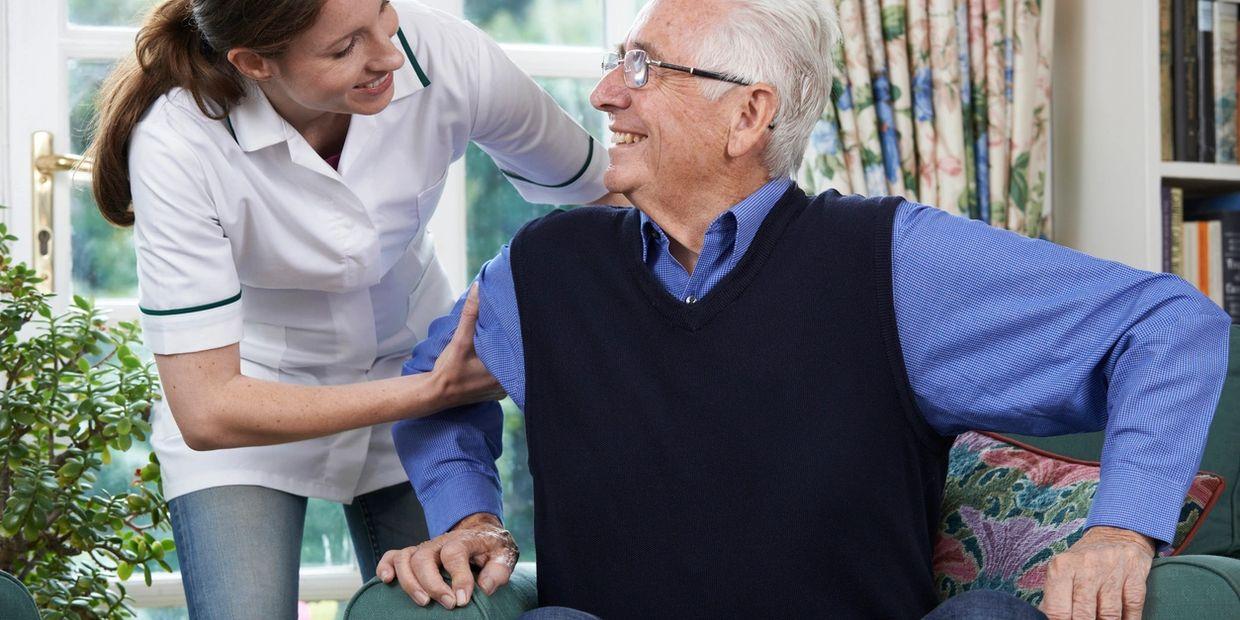 nurse assisting elder in wheelchair